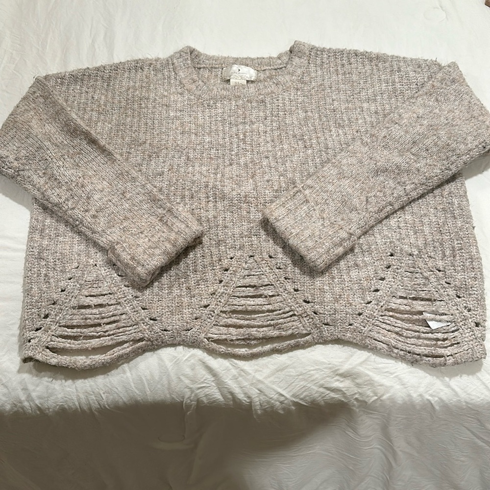 Sweater with distressing. Has a slight crop to it. Well loved with lots of life.